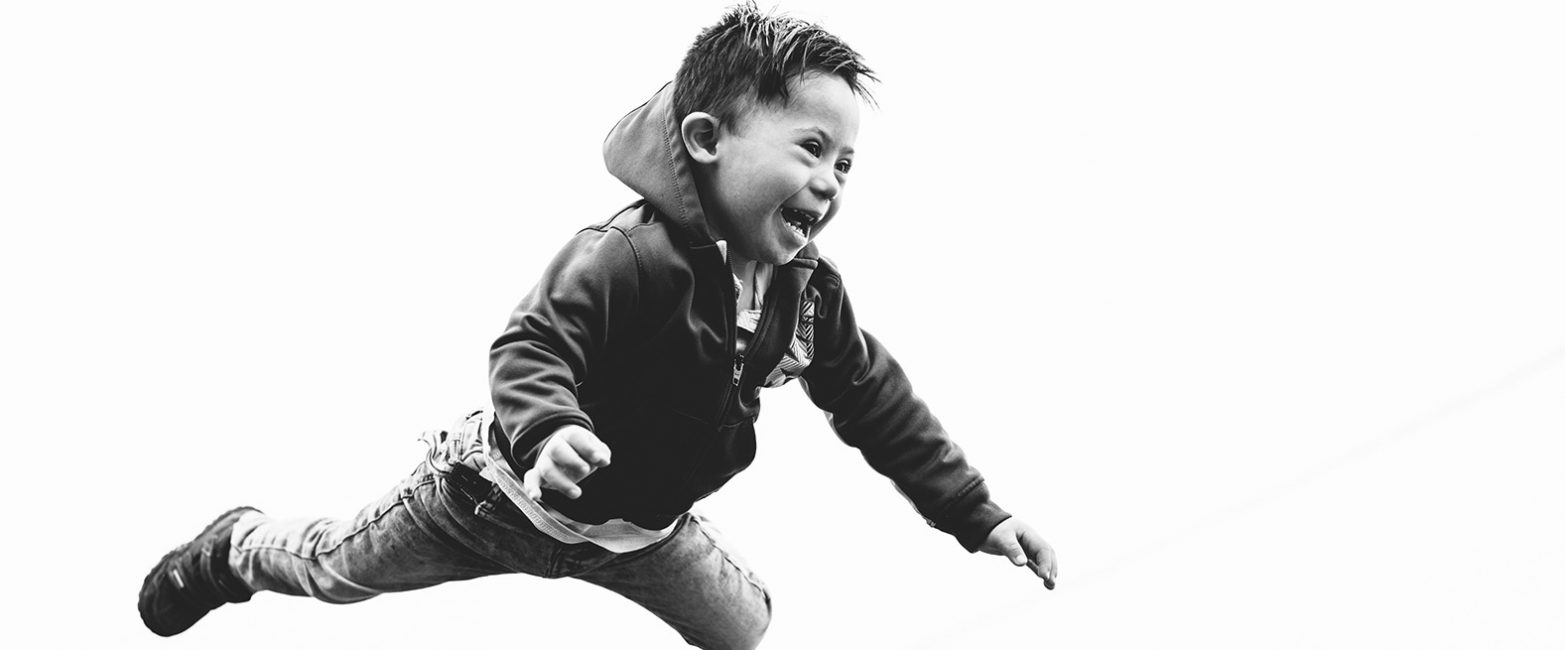 A boy leaping joyfully through the air